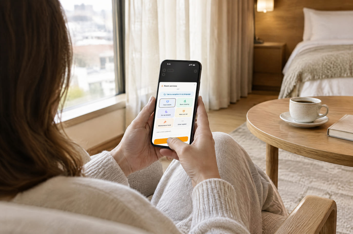 Guest in an armchair in the room opening hotel services on the phone: towels, cleaning and other requests